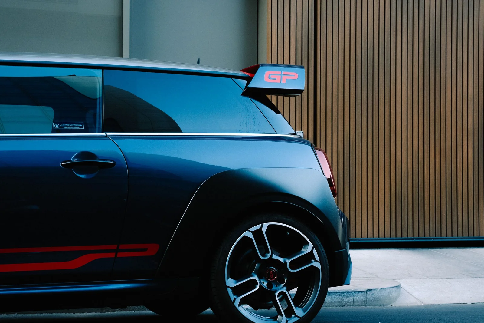 A dark blue hatchback with tinted back windows