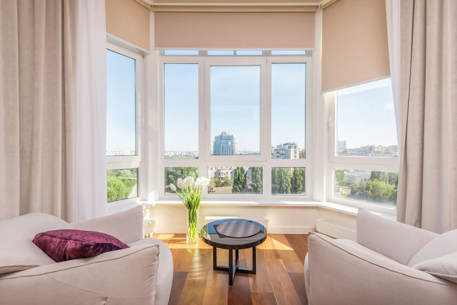 A bright living room with tall sunny windows