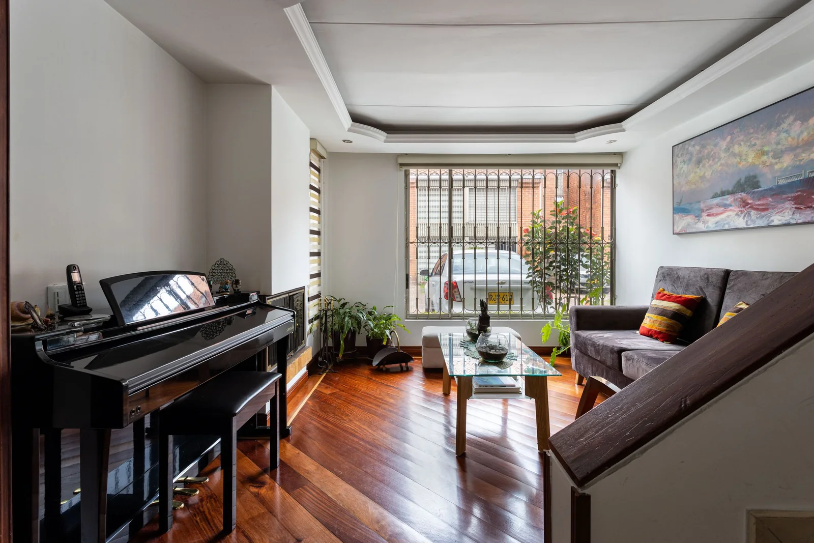 A living room with wood floors and a sunny window
