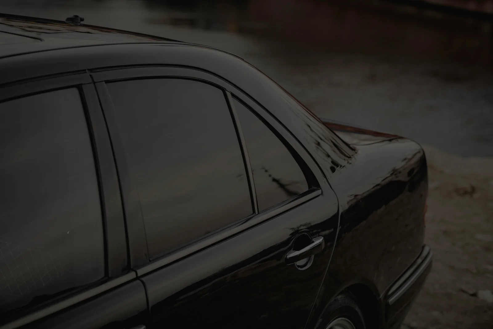 Close-up of a black car’s tinted side windows