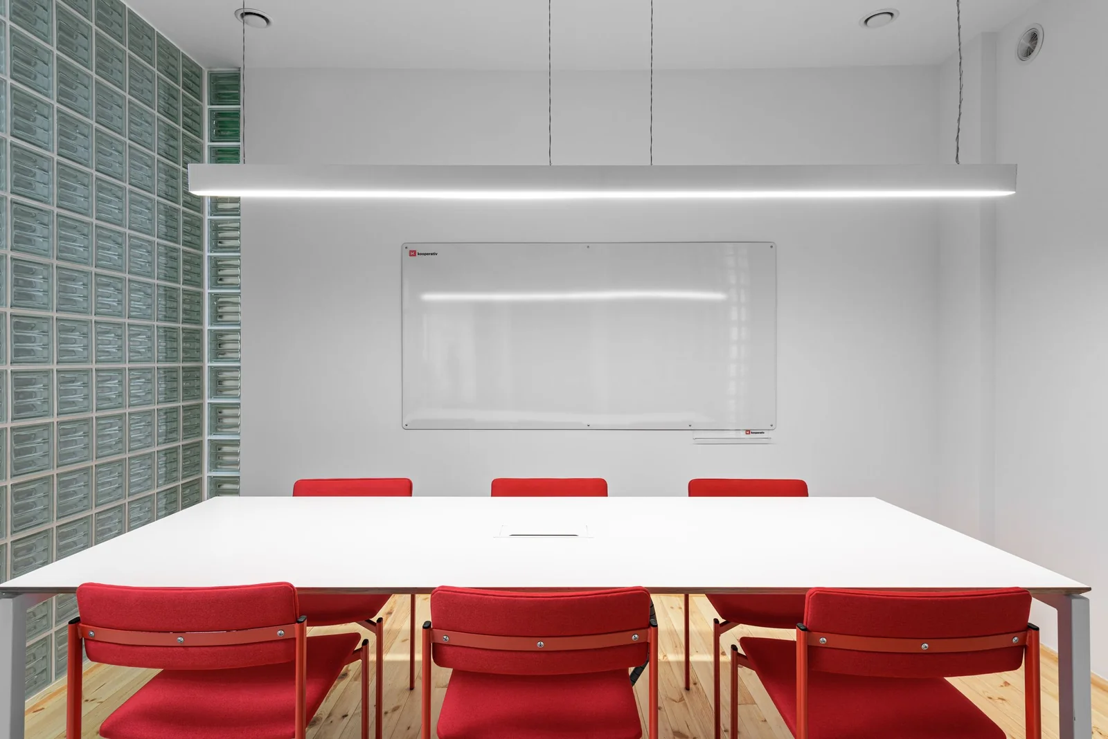 A meeting room with a glass block wall