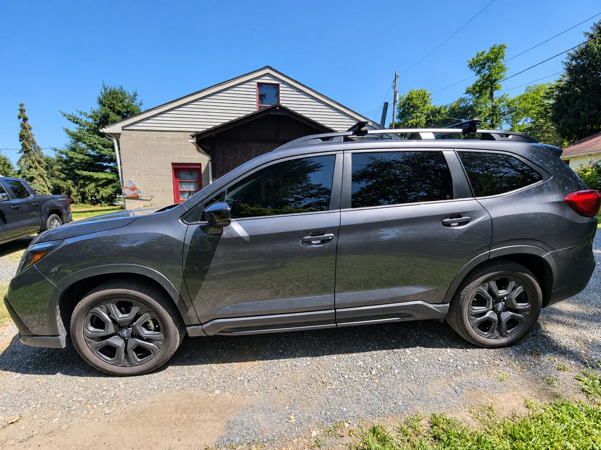 A gray Subaru Ascent with tinted windows on a sunny driveway
