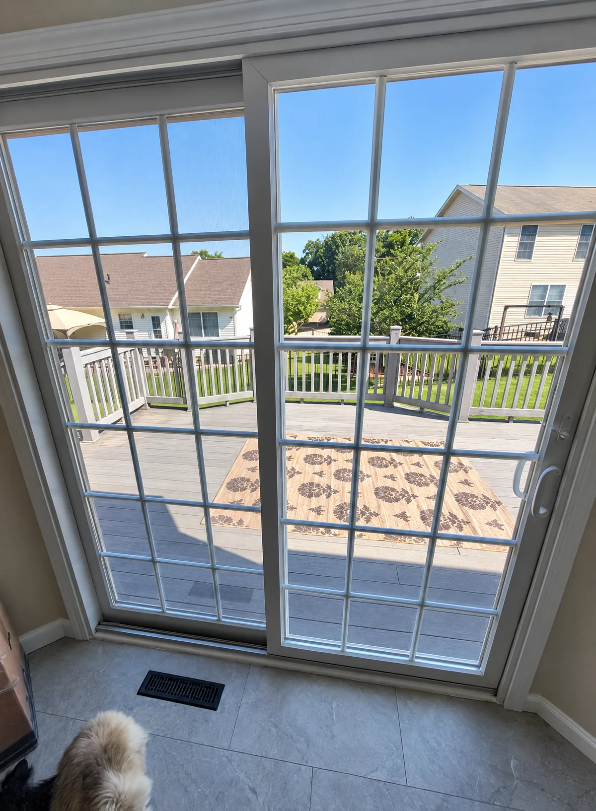 A sliding glass door with window film, seen from inside