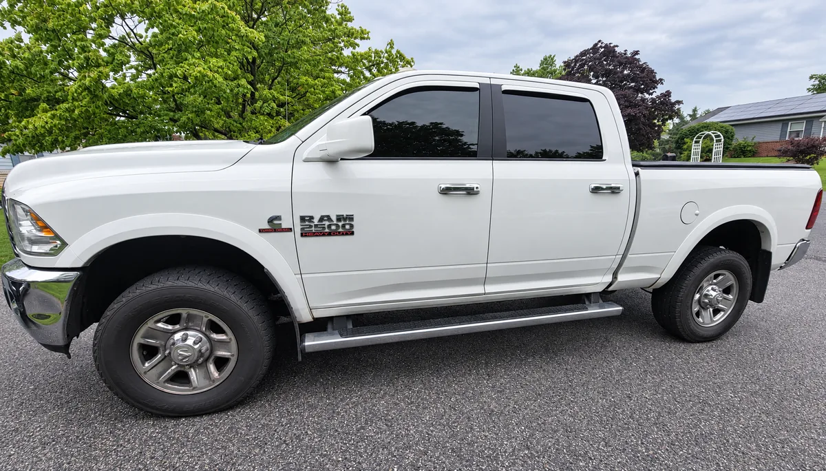 A white Ram 2500 pickup with tinted windows
